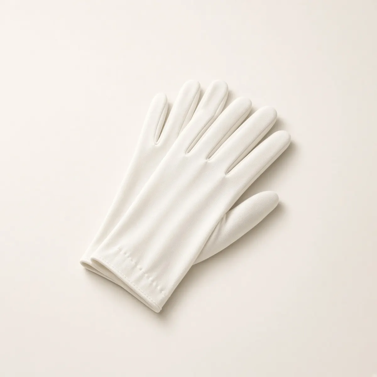 Single white glove on cream background